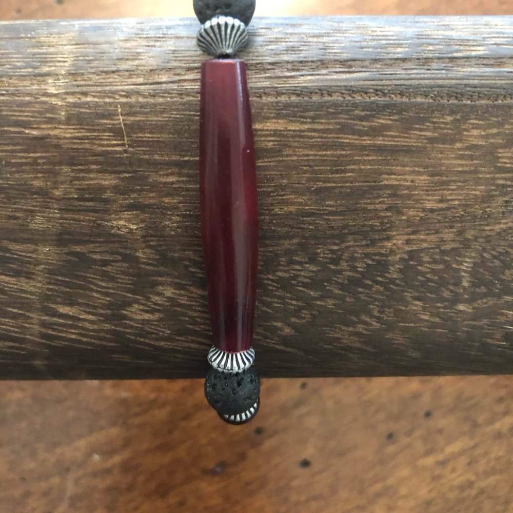 NWOT Black stretchy bracelet with a pop of red.